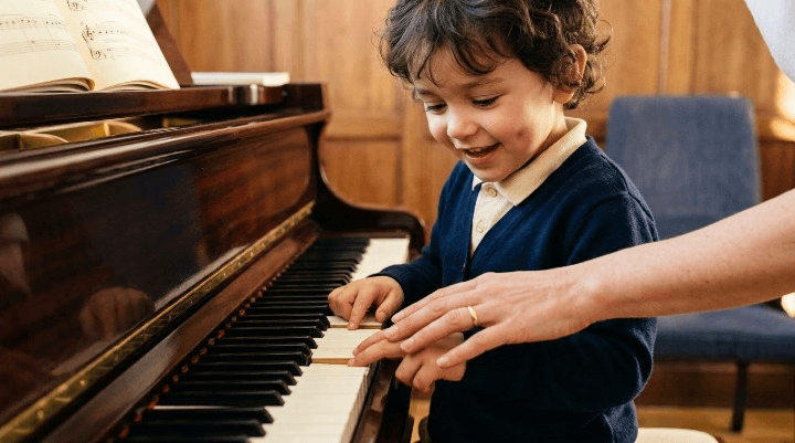 Young child having a piano lesson with a teacher at Excelsis Music School in London